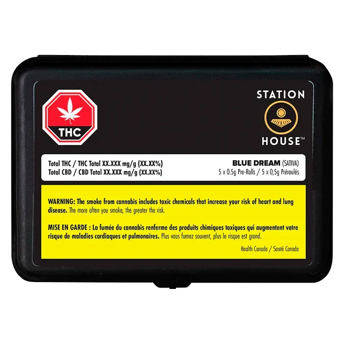 Top-down view of a black rectangular tin labeled Station House with the Blue Dream PR 5 x 0.5 g product name and a yellow health warning panel.