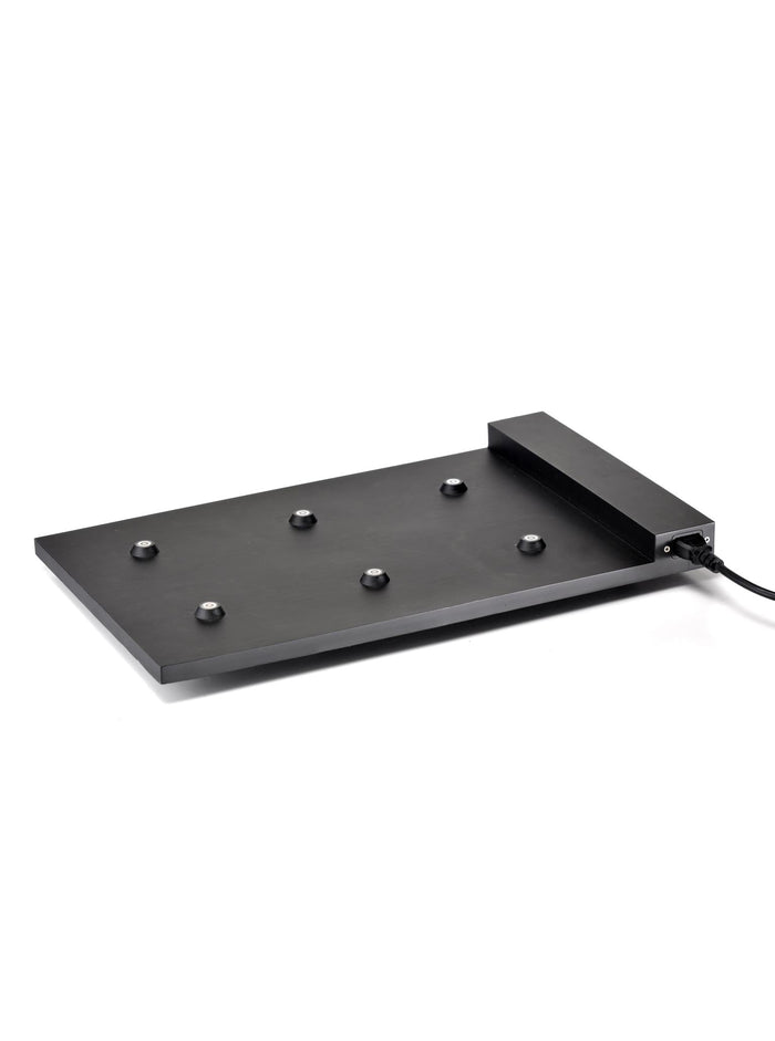 A modern black cordless desk lamp with a unique flat base, including a modular charging system and spherical bulbs on a white background from Zafferano's 6-Lamp Charging Carpet.