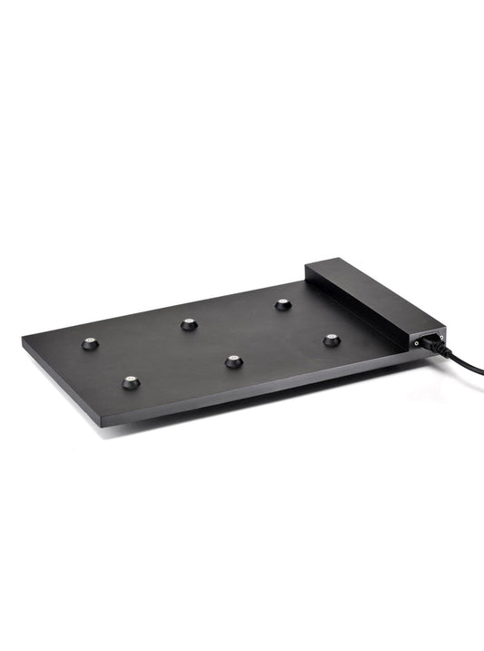 A modern black cordless desk lamp with a unique flat base, including a modular charging system and spherical bulbs on a white background from Zafferano's 6-Lamp Charging Carpet.