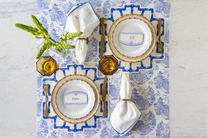 Elegant table setting with Die-cut Blue Bamboo Placemats, Juliska Bamboo plates, gold flatware, Burleigh Blue Place Cards and napkins on the Blue Regal Peacock Runner.