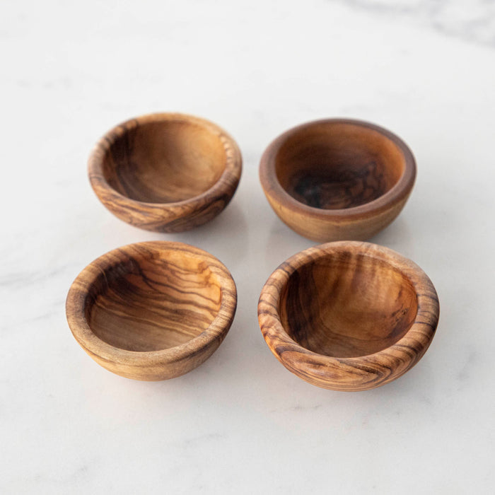 Four Natural Olivewood Pinch Bowls on a white table.